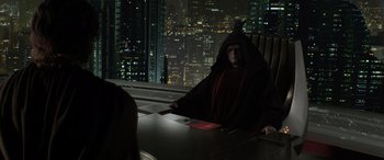 Movie still from “Star Wars: Episode III - Revenge of the Sith” (2005), directed by George Lucas – A man in a red robe sitting in front of a window at night; Medium shot, Over the shoulder angle