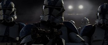 Movie still from “Star Wars: Episode III - Revenge of the Sith” (2005), directed by George Lucas – A star wars character holding a gun; Close Up shot, Low angle