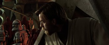 Movie still from “Star Wars: Episode III - Revenge of the Sith” (2005), directed by George Lucas – A man with long hair and a beard holding a sword; Close Up shot, Over the shoulder angle