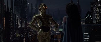 Movie still from “Star Wars: Episode III - Revenge of the Sith” (2005), directed by George Lucas – A woman standing next to a star wars character; Medium shot, Over the shoulder angle