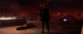 Movie still from “Star Wars: Episode III - Revenge of the Sith” (2005), directed by George Lucas – A man standing in front of a body in a dark room; Wide shot, High angle