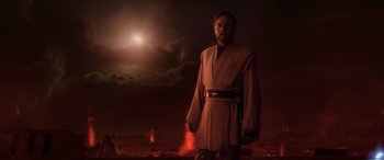 Movie still from “Star Wars: Episode III - Revenge of the Sith” (2005), directed by George Lucas – A man standing in front of a red sky; Medium shot, Low angle