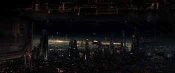 Movie still from “Star Wars: Episode III - Revenge of the Sith” (2005), directed by George Lucas – A view of a city at night from a plane window; Extreme Wide shot, Overhead angle