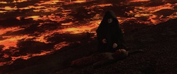 Movie still from “Star Wars: Episode III - Revenge of the Sith” (2005), directed by George Lucas – A woman in a black robe kneeling over a dead body; Wide shot, High angle
