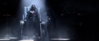 Movie still from “Star Wars: Episode III - Revenge of the Sith” (2005), directed by George Lucas – Darth vader and emperor palpatine in a dark room; Wide shot, Low angle