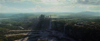 An aerial view of a castle and a waterfall
