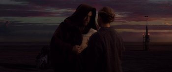 Movie still from “Star Wars: Episode III - Revenge of the Sith” (2005), directed by George Lucas – A man and a woman are looking at a piece of paper; Medium shot, Over the shoulder angle