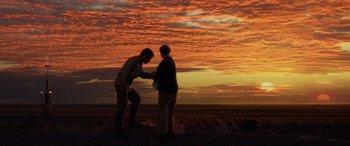 Movie still from “Star Wars: Episode III - Revenge of the Sith” (2005), directed by George Lucas – A couple of people standing on top of a dirt hill; Wide shot, Low angle