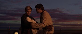 Movie still from “Star Wars: Episode III - Revenge of the Sith” (2005), directed by George Lucas – A man and a woman are holding a baby; Medium shot, Low angle