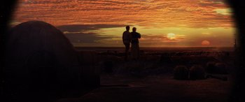 Movie still from “Star Wars: Episode III - Revenge of the Sith” (2005), directed by George Lucas – Two people standing on the beach watching the sunset; Extreme Wide shot, Low angle