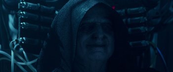 Movie still from “Star Wars: Episode IX - The Rise of Skywalker” (2019), directed by J.J. Abrams – An old man wearing a hooded sweatshirt in the dark; Close Up shot, Over the shoulder angle