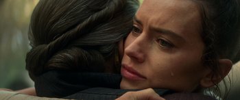 Movie still from “Star Wars: Episode IX - The Rise of Skywalker” (2019), directed by J.J. Abrams – A person with their head resting on the shoulder of another person; Close Up shot, Over the shoulder angle