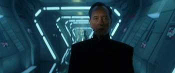 Movie still from “Star Wars: Episode IX - The Rise of Skywalker” (2019), directed by J.J. Abrams – An older man standing in a hallway with lights; Close Up shot, Low angle