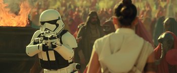 Movie still from “Star Wars: Episode IX - The Rise of Skywalker” (2019), directed by J.J. Abrams – A person in a stormtrooper outfit and a crowd of people; Medium shot, Over the shoulder angle