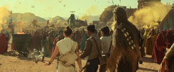 Movie still from “Star Wars: Episode IX - The Rise of Skywalker” (2019), directed by J.J. Abrams – A group of people walking on a dirt ground; Wide shot, Over the shoulder angle