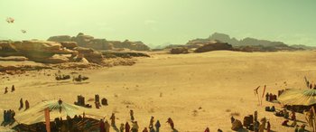 Movie still from “Star Wars: Episode IX - The Rise of Skywalker” (2019), directed by J.J. Abrams – A group of people standing on top of a sandy beach; Extreme Wide shot, High angle