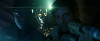 Movie still from “Star Wars: Episode IX - The Rise of Skywalker” (2019), directed by J.J. Abrams – A man and a robot in a dark room; Close Up shot, Over the shoulder angle