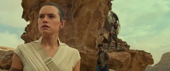 Movie still from “Star Wars: Episode IX - The Rise of Skywalker” (2019), directed by J.J. Abrams – A woman standing next to a man on top of a mountain; Medium shot, Low angle