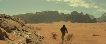 Movie still from “Star Wars: Episode IX - The Rise of Skywalker” (2019), directed by J.J. Abrams – A man in a gorilla costume running through the desert; Extreme Wide shot, High angle
