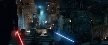 Movie still from “Star Wars: Episode IX - The Rise of Skywalker” (2019), directed by J.J. Abrams – A man holding a light saber while standing on a street; Extreme Wide shot, Low angle