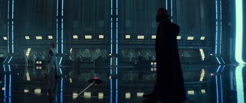 Movie still from “Star Wars: Episode IX - The Rise of Skywalker” (2019), directed by J.J. Abrams – A man in a dark room looking at an object in the dark; Wide shot, Low angle