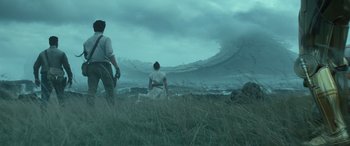 Movie still from “Star Wars: Episode IX - The Rise of Skywalker” (2019), directed by J.J. Abrams – Two people sitting in a field looking at the ocean; Extreme Wide shot, Low angle