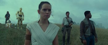 Movie still from “Star Wars: Episode IX - The Rise of Skywalker” (2019), directed by J.J. Abrams – A woman and a man standing in a grassy field; Medium shot, Low angle