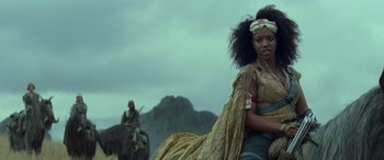 Movie still from “Star Wars: Episode IX - The Rise of Skywalker” (2019), directed by J.J. Abrams – A woman sitting on top of a horse in a field; Medium shot, Low angle