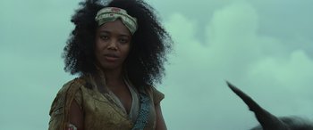 Movie still from “Star Wars: Episode IX - The Rise of Skywalker” (2019), directed by J.J. Abrams – A black woman with long black hair wearing a headband; Close Up shot, Low angle