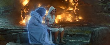 Movie still from “Star Wars: Episode IX - The Rise of Skywalker” (2019), directed by J.J. Abrams – A woman sitting next to an old woman in front of a fire; Medium shot, Over the shoulder angle