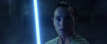 Movie still from “Star Wars: Episode IX - The Rise of Skywalker” (2019), directed by J.J. Abrams – A person holding a light saber; Close Up shot, Over the shoulder angle