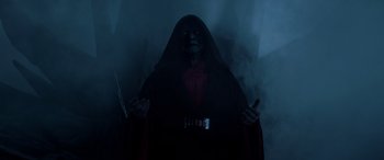 Movie still from “Star Wars: Episode IX - The Rise of Skywalker” (2019), directed by J.J. Abrams – A man in a black robe holding a sword in the dark; Medium shot, Low angle