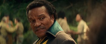 Movie still from “Star Wars: Episode IX - The Rise of Skywalker” (2019), directed by J.J. Abrams – An older man with black hair wearing a green neck tie; Close Up shot, Low angle