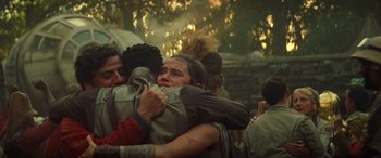 Movie still from “Star Wars: Episode IX - The Rise of Skywalker” (2019), directed by J.J. Abrams – A group of people hugging each other in a forest; Medium shot, Low angle