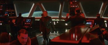 Movie still from “Star Wars: Episode VIII - The Last Jedi” (2017), directed by Rian Johnson – A man in a uniform standing in front of a window; Wide shot, Over the shoulder angle