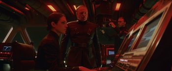 Movie still from “Star Wars: Episode VIII - The Last Jedi” (2017), directed by Rian Johnson – A man and a woman are looking at a computer; Medium shot, Low angle