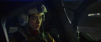 Movie still from “Star Wars: Episode VIII - The Last Jedi” (2017), directed by Rian Johnson – A woman in a helmet is sitting in a car; Close Up shot, Low angle