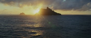 Movie still from “Star Wars: Episode VIII - The Last Jedi” (2017), directed by Rian Johnson – The sun is setting over the ocean with a large island in the background; Extreme Wide shot, Low angle