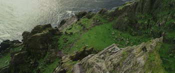 Movie still from “Star Wars: Episode VIII - The Last Jedi” (2017), directed by Rian Johnson – An aerial view of a grassy area near the ocean; Extreme Wide shot, Overhead angle