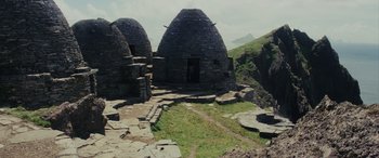 Movie still from “Star Wars: Episode VIII - The Last Jedi” (2017), directed by Rian Johnson – An old stone building on the side of a mountain; Extreme Wide shot, Low angle