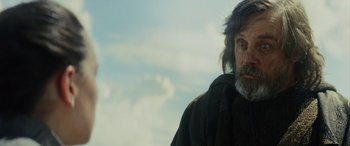 Movie still from “Star Wars: Episode VIII - The Last Jedi” (2017), directed by Rian Johnson – A man with long hair and a beard wearing a black jacket; Close Up shot, Low angle