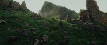 Movie still from “Star Wars: Episode VIII - The Last Jedi” (2017), directed by Rian Johnson – A person is walking up a hill with a mountain in the background; Extreme Wide shot, High angle