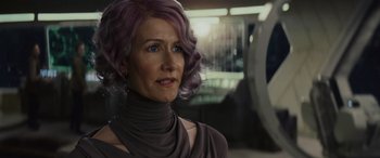 Movie still from “Star Wars: Episode VIII - The Last Jedi” (2017), directed by Rian Johnson – A woman with purple hair is looking at the camera; Close Up shot, Over the shoulder angle