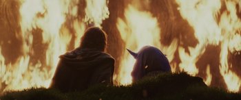 Movie still from “Star Wars: Episode VIII - The Last Jedi” (2017), directed by Rian Johnson – Two people sitting in the grass near a fire; Medium shot, Over the shoulder angle