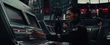 Movie still from “Star Wars: Episode VIII - The Last Jedi” (2017), directed by Rian Johnson – A man in a uniform working on a computer; Close Up shot, Low angle