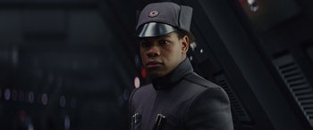 Movie still from “Star Wars: Episode VIII - The Last Jedi” (2017), directed by Rian Johnson – A man in a black jacket and a hat; Close Up shot, Low angle
