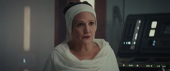 Movie still from “Star Wars: Episode VIII - The Last Jedi” (2017), directed by Rian Johnson – A woman wearing a head band and a white sweater; Close Up shot, Over the shoulder angle