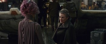 Movie still from “Star Wars: Episode VIII - The Last Jedi” (2017), directed by Rian Johnson – A woman in a brown coat is talking to another woman; Medium shot, Over the shoulder angle