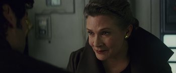 Movie still from “Star Wars: Episode VIII - The Last Jedi” (2017), directed by Rian Johnson – A person sitting down looking at something; Close Up shot, Over the shoulder angle