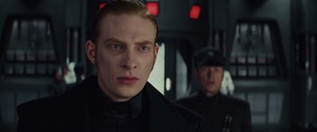 Movie still from “Star Wars: Episode VIII - The Last Jedi” (2017), directed by Rian Johnson – A man in a black shirt and a man in a black suit; Close Up shot, Over the shoulder angle